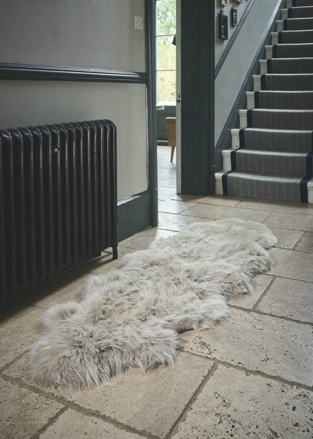 oyster sheepskin rug lay on floor