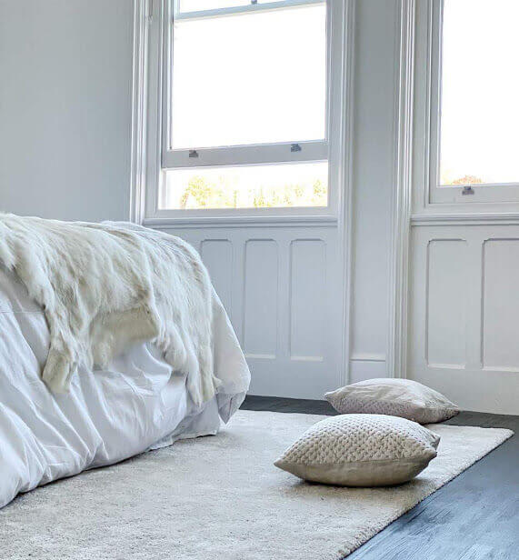 white reindeer hide draped on bed