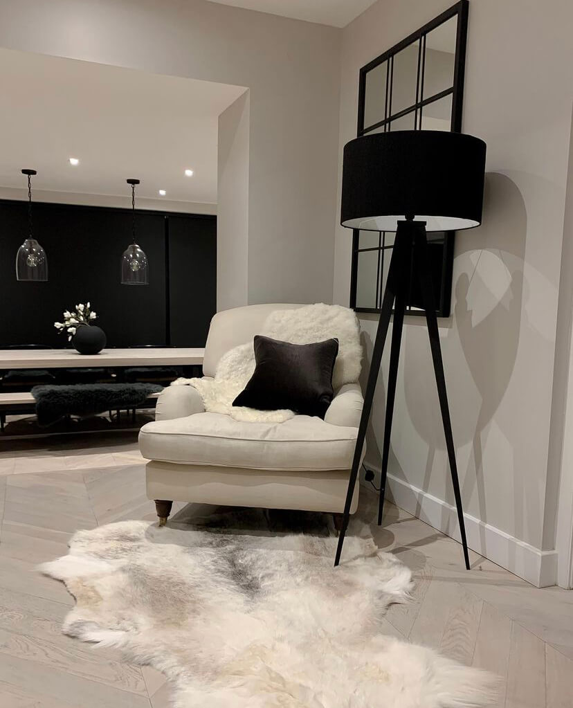 Light-toned reindeer hide rug styled in Scandinavian interior