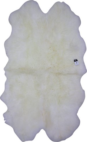 Oversize ivory sheepskin rug styled in a Scandinavian living room