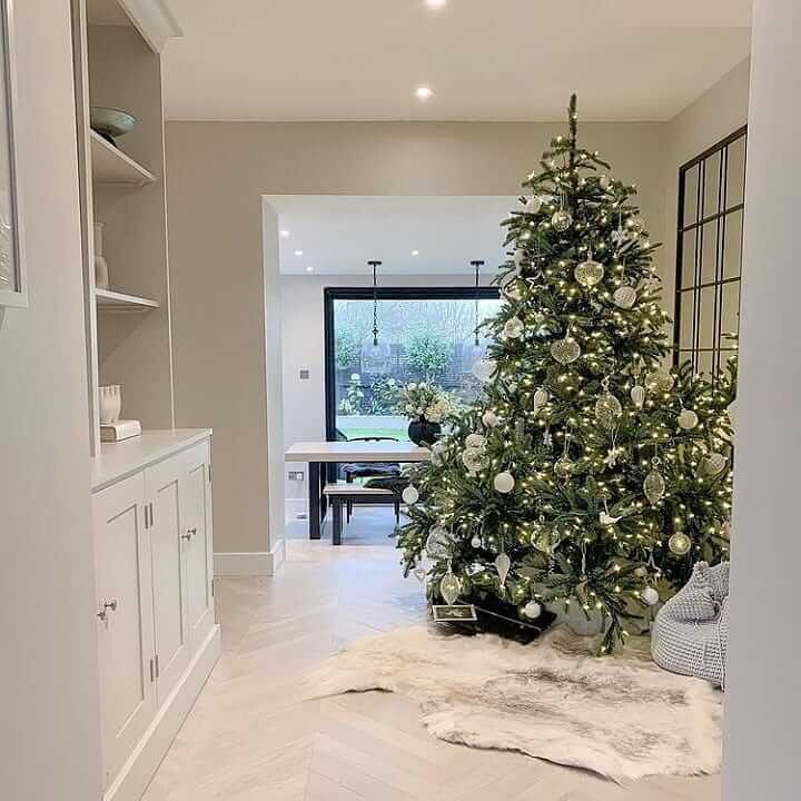 Ethically sourced reindeer hide rug with natural markings and soft texture by christmas tree 