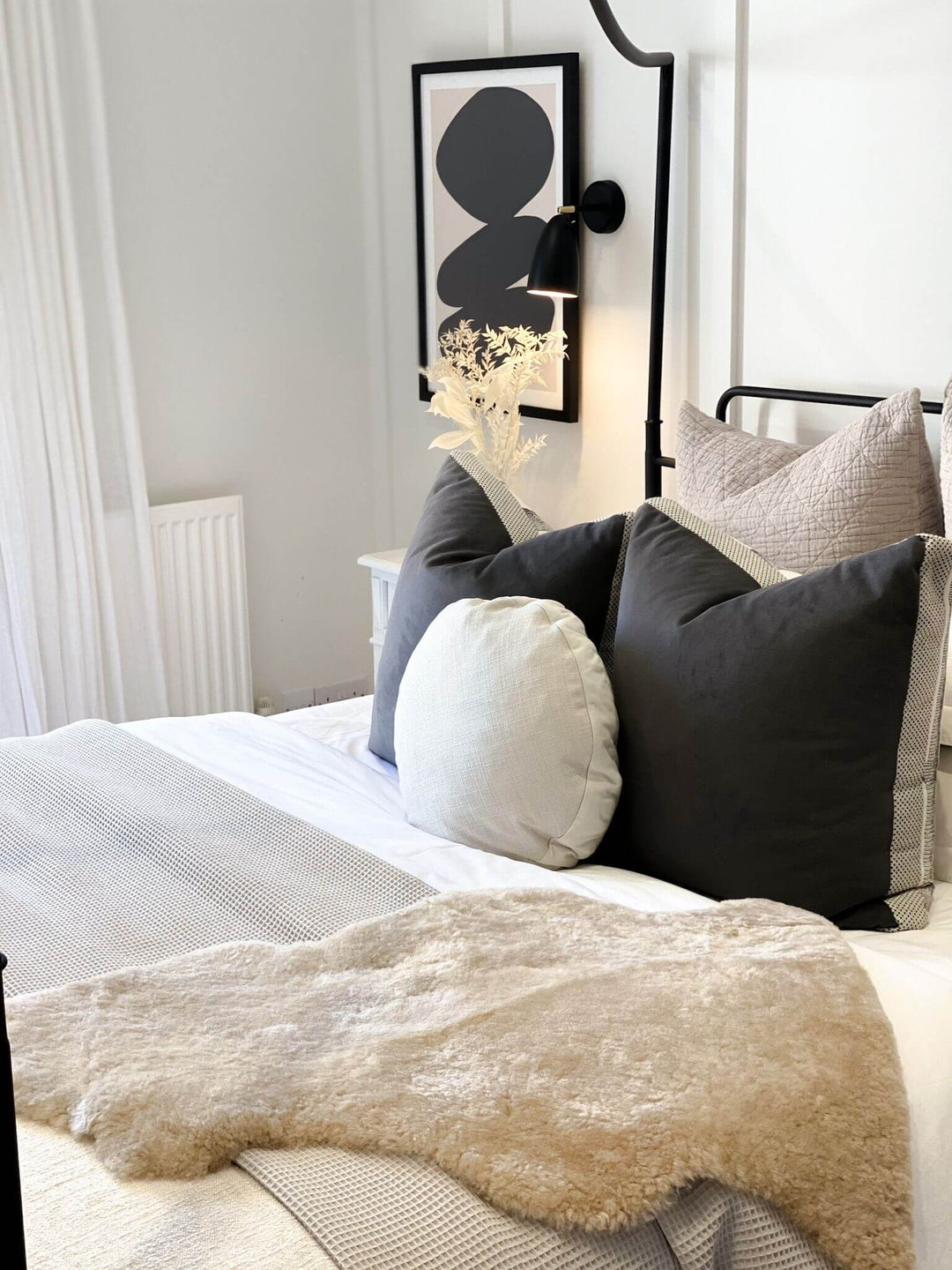 oyster sheepskin on bed draped in scandi style room 