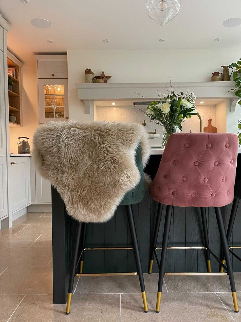Oyster sheepskin draped on chair in kitchen