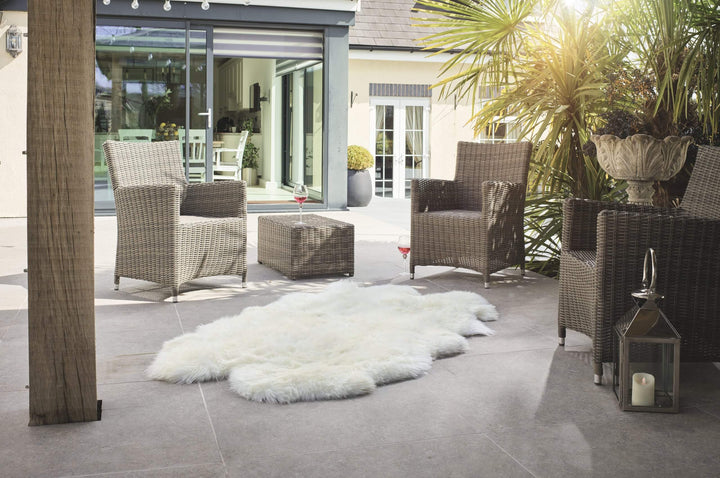 Oversize ivory sheepskin rug styled in a Scandinavian living room