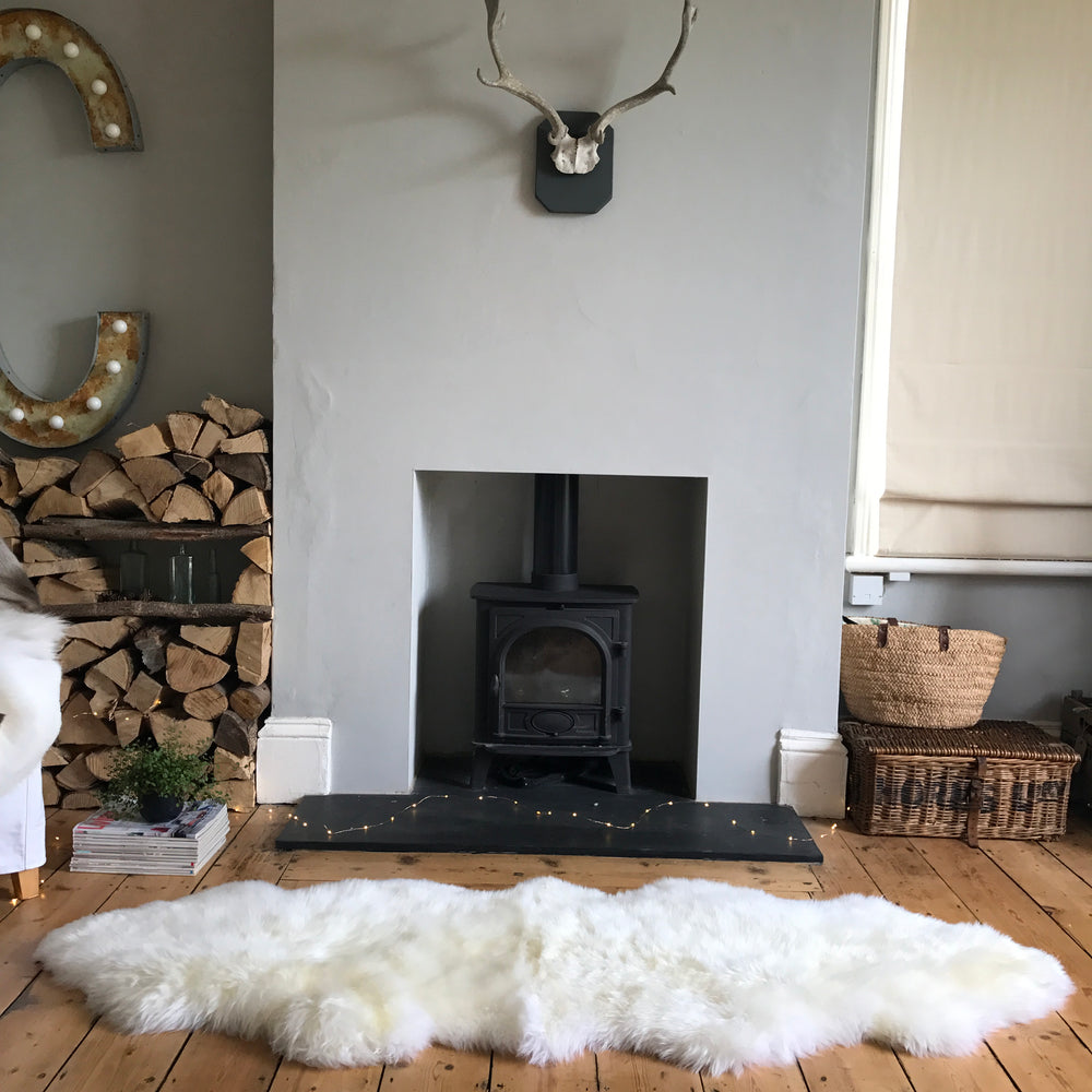 white double sheepskin on wooden floor 