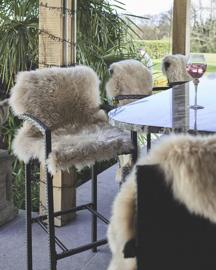 Oyster sheepskin draped on a bar stool