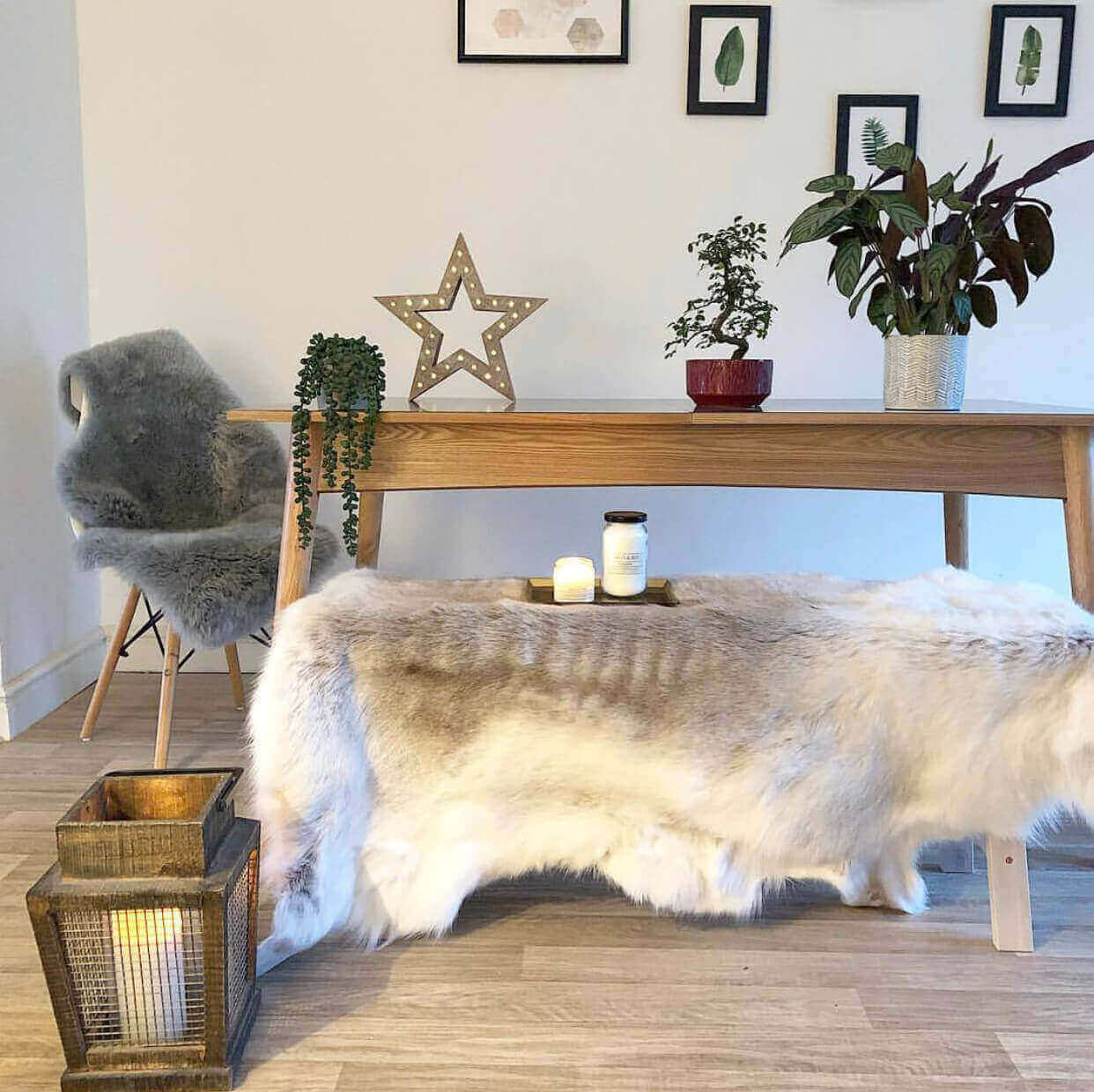 Light-toned reindeer hide rug styled in Scandinavian interior