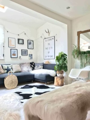 Modern living room with a sectional sofa, decorative pillows, and wall art.