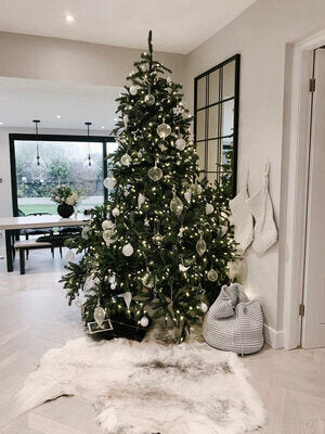 reindeer hide in Christmas setting by a Christmas tree 
