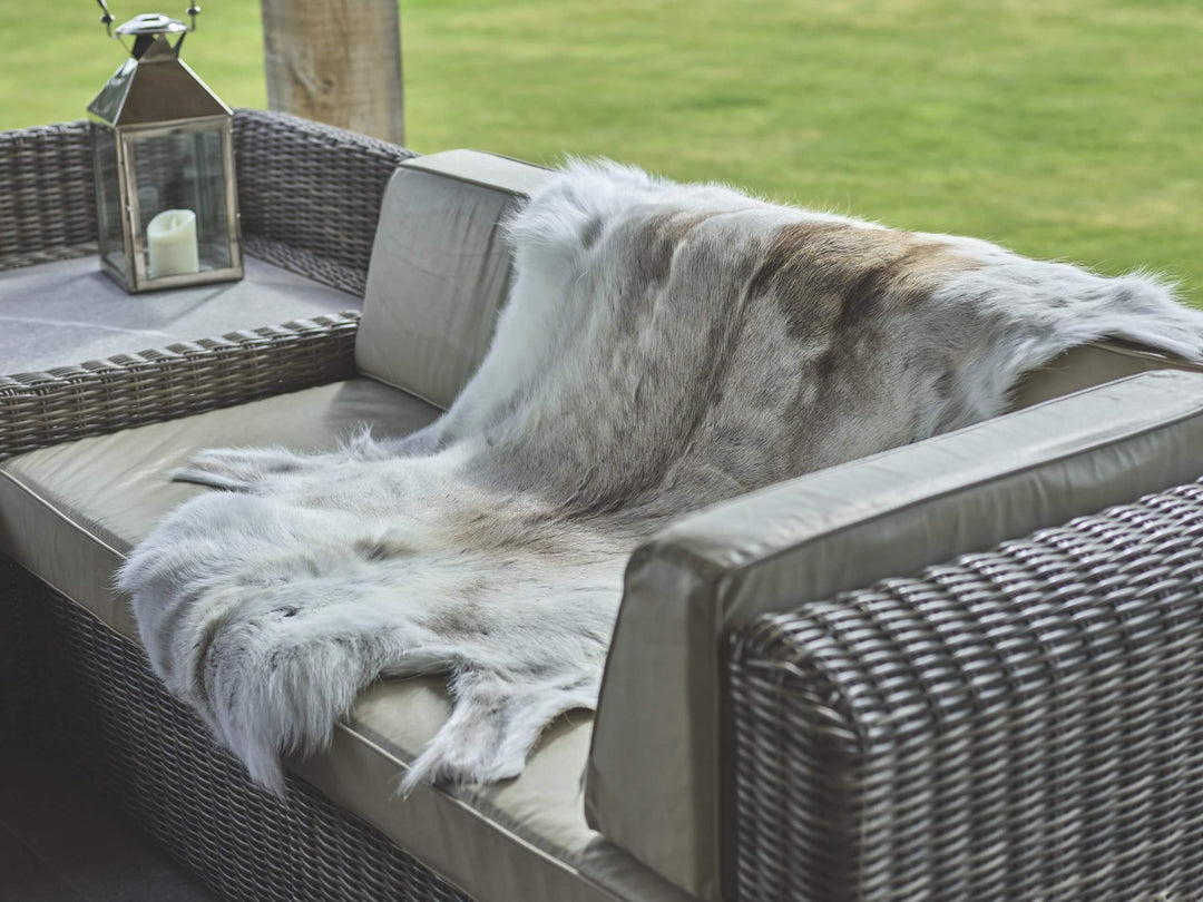 reindeer hide draped over rattan furniture 