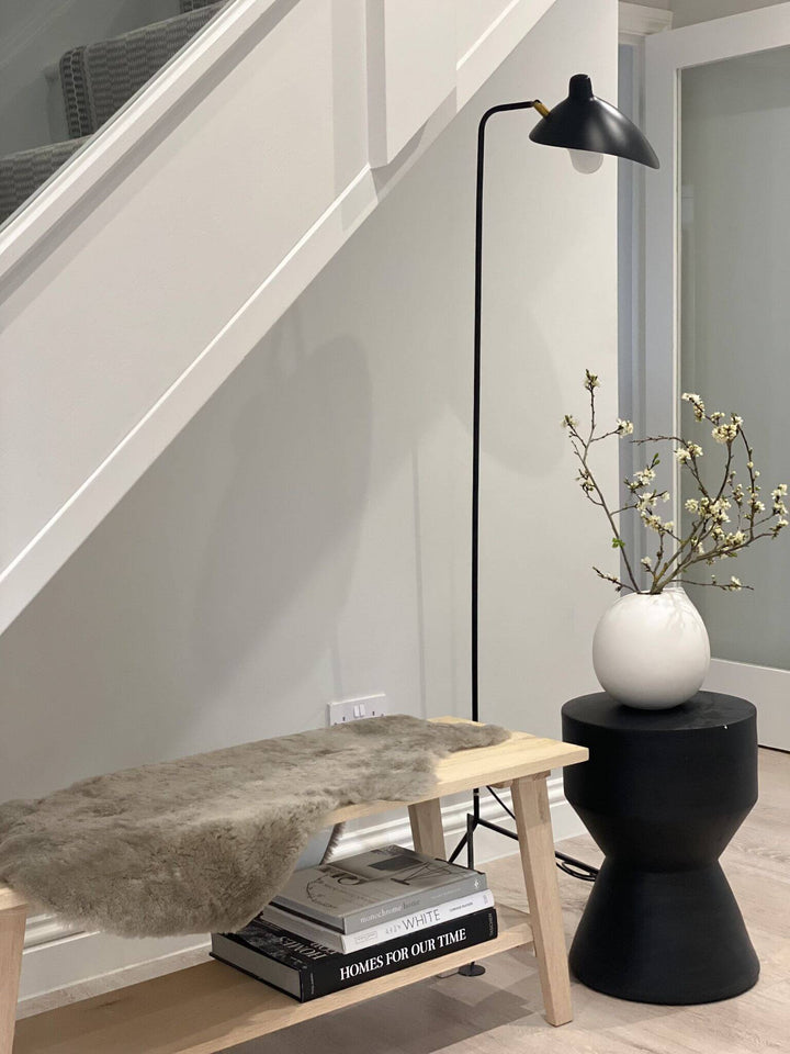 taupe sheepskin draped on bench in hallway 